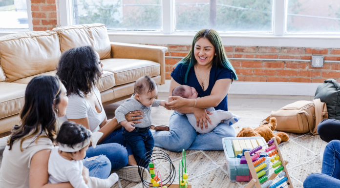 Group of women with babies playing on the floor
