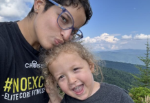 Image: A mother and son with mountains in the background