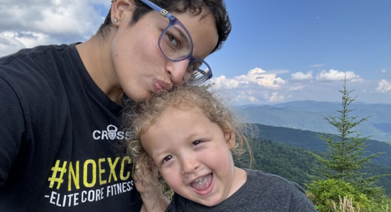 Image: A mother and son with mountains in the background