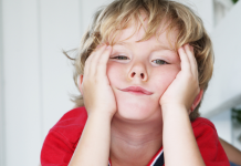 Summer Break: Surviving the Summer Daze Little boy with hands on his face who appears bored