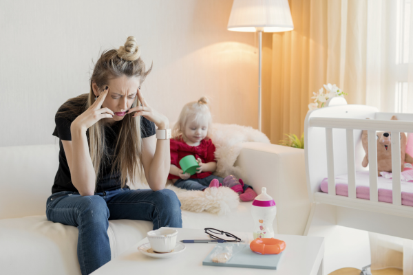 Mom exhausted next to toddler