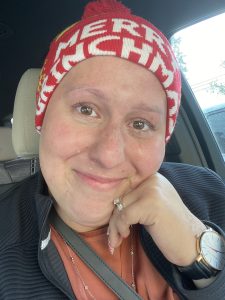 Image: A selfie of Jackie, smiling through tears as she sits in her car