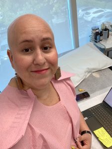 Image: Jackie working on her laptop from an exam room