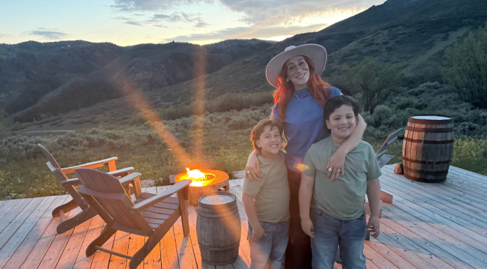 This Summer: What I’m Not Doing as a Mom Image: A mom poses for a photo with her kids in front of a campfire
