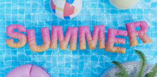 Summer Planning: 6 Tips for When Kids are Home Image: Inflatable letters spelling out SUMMER float on the surface of a pool, framed by beach balls and an inner tube