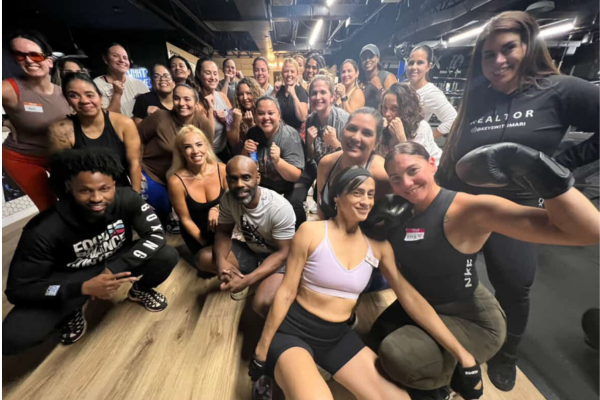 A group of special needs moms are posing together after a boxing and cardio workout.