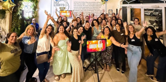 Image: A group of special needs moms are gathered around a karaoke screen for a fun night out.