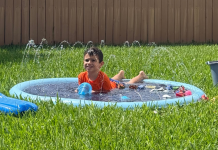 Neurodivergent Families: 3 Summer Survival Tips Image: A young child enjoys a splash pad in the backyard