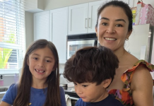 Image: A candid photo of a mother in the kitchen with her children
