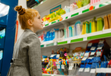 Little girl dressed in a suit looking at school supplies