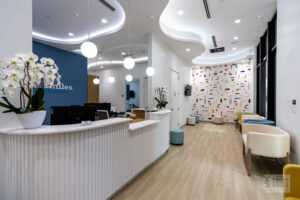 Image: The brightly colored, cheerful, and brightly-lit reception area at All Smiles Pediatric Dentistry in Coral Gables
