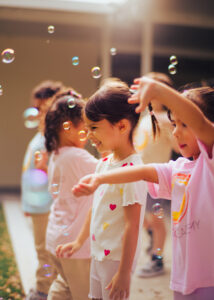 Image: Children playing with bubbles outside