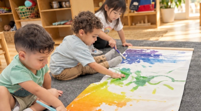 Sol Academy: Building Strong Academic Foundations Image: Three children painting on butcher paper